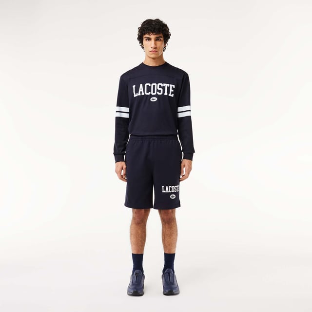 Own the french fashion sport The Joggers tracksuits : Comfort shape Regular fit  regular ease on body  hip and leg Shorts in our classic French Terry Climbing style drawcords 5cm puffed badge with silicone crocodile sewn at bottom Lacoste wording in flock print.