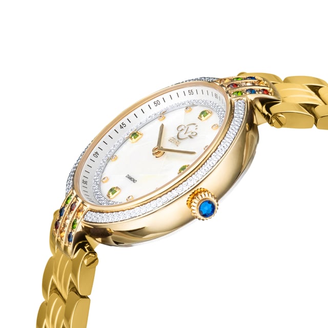 GV2 12803B Women's Matera Gemstone Diamond Watch GV2 Women's Swiss Quartz Gemstone Watch from the Matera Collection 36mm round IPYG Case, Diamond Cut Bezel with 18 Multicolored Gemstones on Lugs. Puzzle White MOP with 8 Single Cut Diamonds on dial, 4 Green Diopside Gemstones Push/Pull Crown IP Yellow Gold Bracelet With Deployment Buckle Anti-reflective Sapphire Crystal Water Resistant to 50 Meters/5ATM Swiss Quartz Movement, Ronda 762