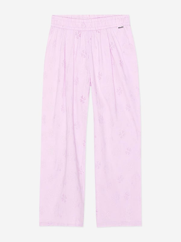 Molo project fun and creative energy into their flawless constructions. These girls floral print alpine glow trousers  are in a broderie anglaise quality both French inspired and divine. They come in organic cotton with an elastic waist and a pleat in the front to emphasise the design on a greater level.  Lining in Same Colour 100% Organic Cotton GOTS Organic Certified By Ecocert Greenlif
