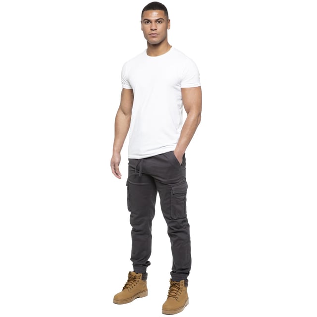 Enzo Mens Elasticated Waist Stretch Cuffed Jeans. Features a 5 Pocket Design. 2 Slash Pockets, 1 Back Pocket 2 Front Cargo, Bellow Side Pockets With Velcro Fastening. Elasticated Waist With Adjustable Drawstings. Cut and Sew Design On Leg. Cuffed Ankle
