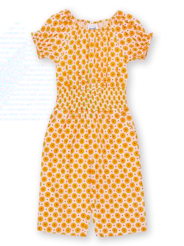 100% organic cotton |  Proud to be certified by Control Union to the Global Organic Textile Standard (GOTS) |  Groovy dot all-over print |  Orange |  Double layer muslin fabric |  Side pockets |  Short sleeved |  Elasticated shirring at waist and sleeves |  3/4 length leg, culotte style legs |  Elasticated neckline |  Made in India |  Machine washable at 40 degrees, or at 30 degrees to be kinder to the planet