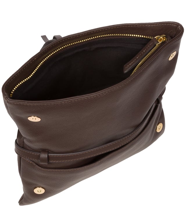 The 'Selene' cross body clutch bag from the Pure Luxuries Marylebone Collection is handcrafted from high-quality, genuine Nappa leather with a natural super-soft touch. The fold-over top secured by two magnetic press studs, opens to reveal a zipped main compartment and a slip pocket. The interior is lined with 100% cotton and includes two slip pockets to help maintain an organised bag. Comes with a matching and adjustable slim leather strap, with a maximum drop length of 65cm. The strap is also removable, transforming the bag into a clutch bag. Features gold-coloured metal fittings and zip. The Pure Luxuries logo is embossed for an effortless and sophisticated finishing touch.