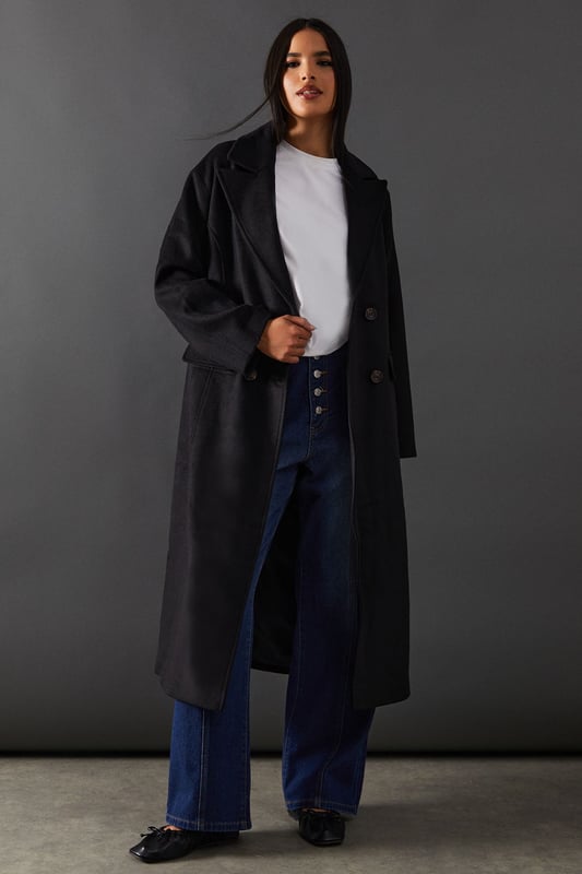 Double-breasted design for a sophisticated silhouette
        Maxi length offering full coverage and dramatic flair
        Wide lapels adding a touch of classic elegance
        Flap pockets for both style and functionality
        Relaxed fit allowing for layering versatility
    
    Make a statement with this striking double-breasted maxi coat from Warehouse. Perfect for the confident woman who appreciates edgy yet feminine style, this coat seamlessly transitions from day to night. The oversized silhouette exudes effortless chic, while the maxi length adds drama to any ensemble. Style it over wide-leg trousers and a chunky knit jumper for a contemporary daytime look. For evening affairs, drape it over a sleek midi dress and pair with heeled boots to create a captivating outfit. The versatile design allows for endless styling possibilities, making it a true wardrobe staple that will serve you well for seasons to come. Whether you're heading to the office or out for dinner, this coat will ensure you arrive in style.