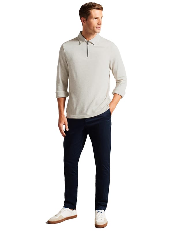 The Ted Baker men's Karpol long sleeve polo shirt in navy offers a refined take on a wardrobe staple. Crafted from a soft modal blend fabric, this polo delivers exceptional comfort and a luxurious feel against the skin. It features a classic collar and a zip placket, adding a modern twist to the timeless design. The long sleeves make it a versatile piece, suitable for both casual and smart-casual looks, providing style and ease for any occasion.