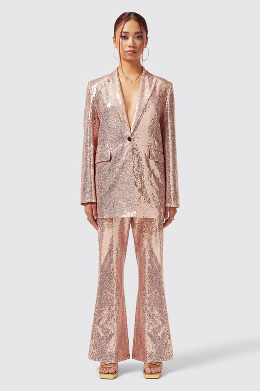 The Caladium Trouser in Rose Gold is a go-to party and event favourite. Adorned with shimmering sequins, It's guaranteed to turn heads as soon as you enter the room. Cut to a slim fit with a flared leg, it's the perfect pair of trousers with a rose gold twist. Pair it with the matching Caladium Jacket in Rose Gold to complete the full look.
