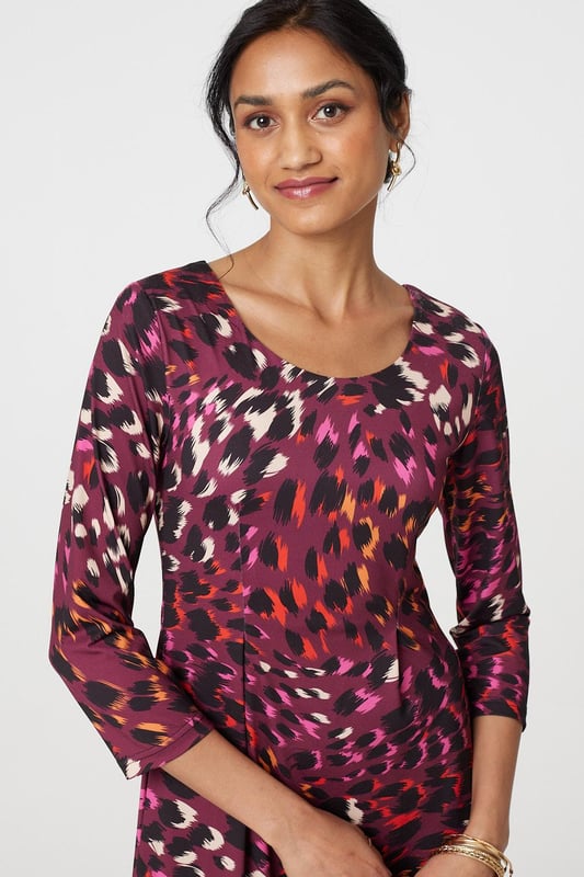 Add a vibrant animal print to your new season closet with this anima print midi dress. With a round neck, 3/4 sleeves, a hanky hem and a midi skirt. Style with strappy hees for a special event or pair with tights and block heeled boots to beat the chill.