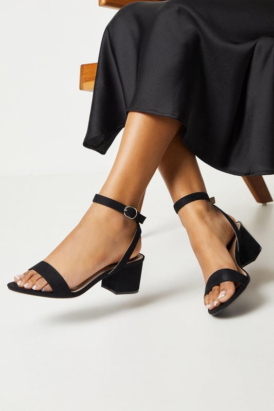 Wide fit design offers a comfortable and accommodating fit
Barely-there strappy silhouette with minimalist appeal
Mid block heel provides a modest lift and walkable height
Faux leather upper exudes a look and feel
Ankle strap with buckle closure ensures a secure fit

These versatile sandals are perfect for casual daytime outings or relaxed evening affairs. Pair them with a flowy midi dress or cropped trousers for a chic, on-trend look that transitions seamlessly from brunch with friends to an evening baby shower. The neutral hue complements a variety of ensembles, allowing you to showcase your personal style effortlessly.