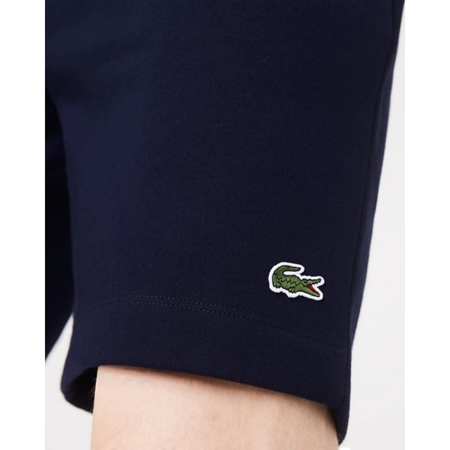PRODUCT REF. GH9627-00 Efficient. Durable. Comfortable. An iconic, performance-enhancing essential that's comfortable enough to relax in. Regular fit, straight cut: Unrestricted freedom of movement. Drawstring waist: An adjustable waistband for optimum comfort. Back pocket with piping: Practical and functional. Embroidered crocodile on the front: Lacoste-typical performance. Brushed organic cotton fleece: Long-lasting comfort during sports. Main material: cotton (84%), polyester (16%) / pocket lining: cotton (100%)