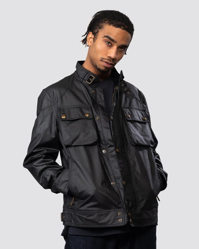 The Racemaster jacket in Faded Olive. There’s more to the Racemaster than meets the eye. Introduced back in 1981, it was originally billed as a shorter version of the iconic Trialmaster. This means that, along with the history, heritage, and dark navy 6 oz. waxed cotton, you also get increased mobility and freedom to move.

6 oz. waxed cotton, with a unique blend of micro and technical waxes
Four external pocket field jacket with reinforcement patches and corduroy details
Water-repellent and wind-repellent
Corduroy linings at the collar, cuffs and hem providing added comfort and resilience at high contact points
Signature antique brass metal hardware with Belstaff England engraved on the round and signature phoenix woven patch on left sleeve
Centre front zip closure with snap closure placket
Buckle-adjusted collar
Two press-stud flap pockets
Two lower zipped pockets
Left internal pocket

Shell: 100% Cotton, Body Lining: 100% CottonSleeve Lining: 55% Polyester, 45% Viscose/Rayon105306