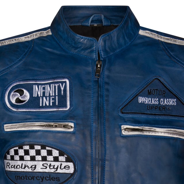 Finished in our premium nappa leather and detailed with our embroidered vintage badges, racing enthusiasts look no further. The classic biker style is levelled up with the addition of twin contrasting racing stripes on the sleeves and a thoughtful placement of racing badges to make this iconic piece. The jacket still stays true to its biker roots with a classic short tab collar and two zip pockets positioned at the breast for a traditional look. For additional storage find two hand pockets at the waist as well as a further two compartments integrated in the lining, to ensure this jacket is as practical as it is stylish.  • 100% premium ultra-soft nappa leather. • Four exterior and two internal pockets • Racing style stripes on each of the jacket sleeves • Full length YKK zip on the front • Embroidered racing style badges featured across the jacket front and sleeves