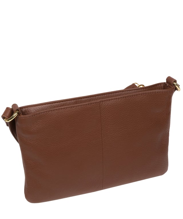 Handcrafted from super soft natural Nappa leather, the 'Jess' cross body bag from Pure Luxuries London's Marylebone Collection is a must-have thanks to the spacious design. The dual main compartments are secured with a zip-over top which opens to reveal the luxurious 10% cotton lining. Additional storage space is provided by two slip pockets in the larger compartment - ideal for maintaining an organised bag. The accessory is adorned with gold-coloured metal fittings and zips which complement the slim and adjustable leather strap with a maximum drop length of 65cm. The Pure Luxuries logo is embossed in gold foil for a beautifully simple finishing touch.