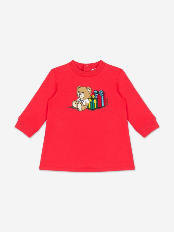 Italian fashion House Moschino depict energy and precision into their fun-filled abstracts. This baby girls poppy red sweater dress is reflective of the label's passion for the teddy bear motif and its reconceptualised forms. It showcases an adorable beady-eyed teddy bear with gifts via delicate embroidery in high quality cotton.‚ Crew Neck‚ Long Sleeves‚ Back Button Closure‚ 95% Cotton, 5% Elastane