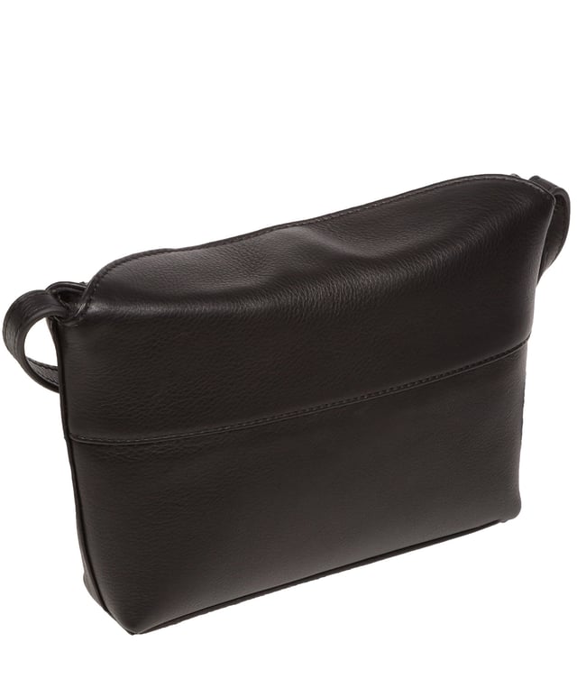 The 'Lolo' cross body bag from the Pure Luxuries Marylebone collection is handcrafted from high-quality, genuine Nappa leather with a natural super-soft touch. The bag is secured by a magnetic closure which opens to reveal a 100% cotton-lined interior and includes two slip pockets. Features gold-coloured metal fittings alongside the adjustable slim leather strap, with a maximum drop length of 65cm. The Pure Luxuries logo is embossed in gold foil for a beautifully simple finishing touch.