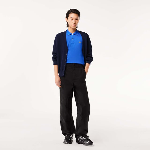 inchLacoste  inventor of the polo since 1933 Original L.12.12 Polo. Made by Lacoste. The Icon. Collar  button placket  petit piqué fabric - these are the components thought by René Lacoste. Yes  René did it first. 90 years ago  he challenged the status quo by creating the first polo to bring more freedom of movement on and off court. And put a crocodile at heart  making Lacoste the first brand who put a logo on clothing. Classic fit  comfortable ease on body and sleeves Original L.12.12 polo in our iconic petit pique renewed every season in a new large color palette. The Petit Piqué fabric is a Lacoste signature. It made of fibers knit together at two different levels of tension. The result? A finely honeycombed fabric that enables air to circulate freely. This fabric ensures comfort  ease of movement and elegance. Ribbed collar and cuffs Side slits Invisible hem Real mother of pearl buttons 3cm green crocodile at chest inch.