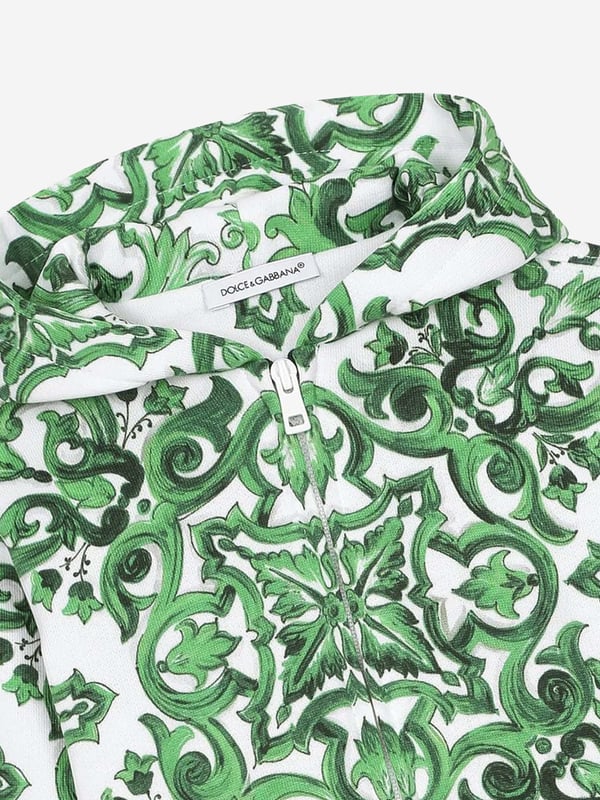 Dolce &amp; Gabbana utilise new technological properties to create captivating aesthetics. This baby boys zip up is a part of the FW24/25 Boy‚ôs Collection that boasts a ‚úcalligraphic-naturalistic‚ù Majolica accent. Crafted in a magnetic two-tone detailing ‚ì bright green and white- cotton jersey design with all-over green majolica print. Inspired by Sicilian tiles, it has ribbed trims and a black script logo on one side. He will be obsessed. ‚ Made in Italy‚ Zip Fastening‚ Machine Wash (30*C)‚ 100% Cotton (Soft Jersey)‚ Lining of Hood: 100% Jersey (Soft Jersey)
