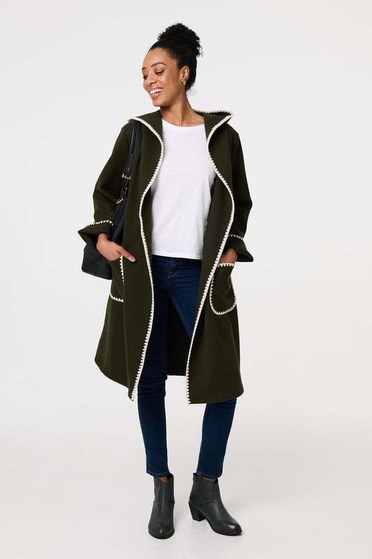 Throw on an extra layer in style with this tie up coat. It's finished with a decorative blanket stitch and front pockets, as well as an adjustable waist tie. The longline thigh length hem will look great layered over trousers, jeans or a skirt, so you can wear it with practically any outfit.