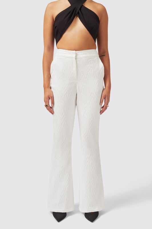 Refresh your wardrobe with the Fiore Trouser in White. Cut to a flared fit it features a jacquard print for added texture and made from a cotton blend to keep you cool. With its classic tailoring it's a great new addition to your collection. Pair it with the matching Fiore Jacket in White to complete the full look.
Model is 5'6" (168cm), chest 32" (81cm), waist 27" (69cm) and wearing a size 8.