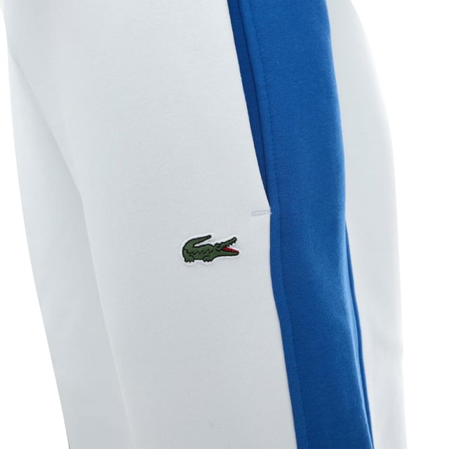 XH9614 Men's Lacoste Contrast Bands Trackpants Tapered fit  natural ease  carrot leg: Close-fitting for maximum movement. Drawstring and piped back pockets: Practical  with immaculate details. Contrast bands:  Your style makes the difference. Embroidered crocodile sewn onto front: Signature Lacoste movement. Brushed cotton fleece:  As warm as it is soft.