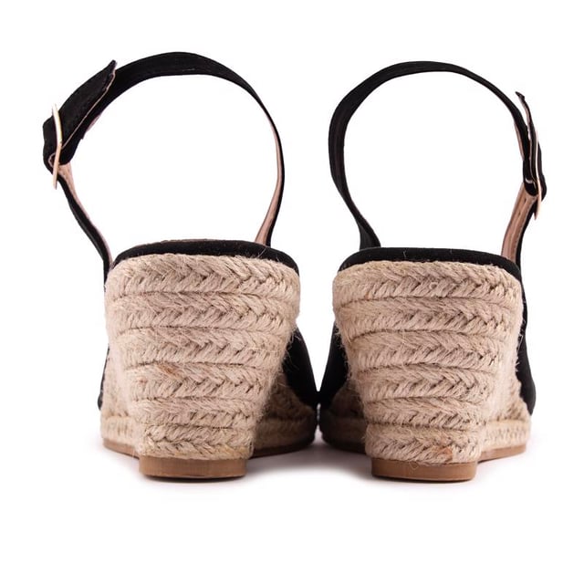 Poets je zomerse stijl af met deze comfy sleehak sandaal-meets-pump van Solesister. De espadrille jute sleehak wordt gecombineerd met een zwart bovenwerk met een verstelbaar enkelbandje. open teen en een wijdere pasvorm. De perfecte aanvulling op je looks voor warmer weer.