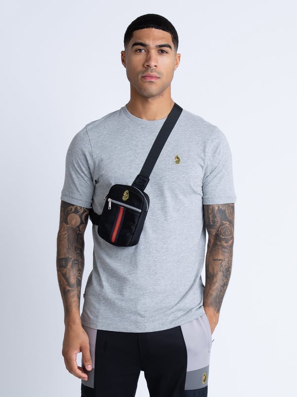 Perfectly portable and compact, this black cross body bag from LUKE is your everyday go to. Constructed from a durable fabrication, that will stand the test of time, it features a zipped main compartment and front pocket, handy to secure all your essentials. It is detailed with striped trim tape at the front and complete with the brand's iconic lion head embroidery at the front.