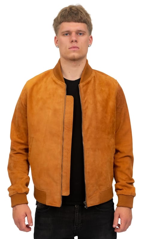 Inspired by the MA-1 style of the 50s, this jacket is an iconic staple of causal outfits and has only gotten more popular as time goes by. We feature this jacket in our quality goat suede for a lightweight feel and smooth appearance which is distinct to suede, the jacket also features elasticated hems and cuffs for added comfort and a tapered appearance. This jacket is kept minimalistic with additions to the front restricted to two subtle waist pockets for that clean bomber look. We recommend pairing this with jeans for a timeless outfit, however this is a very versatile garment, made even more so by the wide range of colourways we offer this jacket in and can therefore feature in practically any outfit you choose. • Made of genuine goat suede • Elasticated hems and cuffs for extra comfort • Classic YKK zip on the jacket front • Features in a range of colours • Includes pockets integrated into the jacket lining and two exterior waist pockets