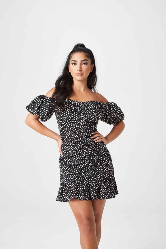 The perfect summer mini dress featuring a flawless fitted silhouette with a spotted pattern and off the shoulder sleeves. The ideal dress for a night out with friends to a holiday centrepiece, this dress will quickly become your favourite. Model is 5'5 and wears a size 8.