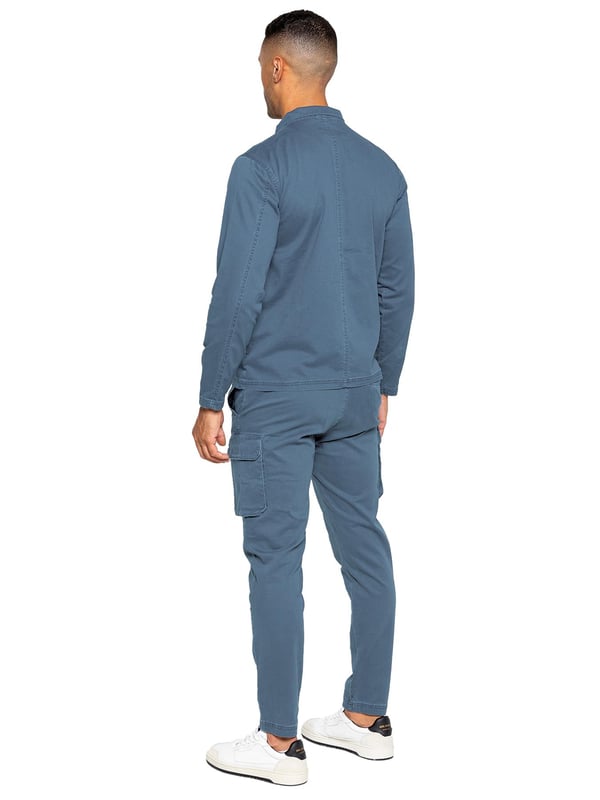 Enzo | Mens Cargo Tracksuit Set Enzo Mens Cargo Outfit Set. Long Sleeved, Zip Up, Collared, Cargo Overshirt. Two Front Flat Cargo Pocket With Velcro Fastening. Two Side Welt Pockets. Stitched Trims On Sleeves And Hemline. Set Completed With Cargo Trousers. Regular Fit, Straight Leg, Enzyme Wash. 5 Pocket Design. 2 Side Pockets, 2 Cargo Pockets With Velcro Fastening. Single Back Welt Pocket. Elasticated Waistband With Adjustable Drawstring