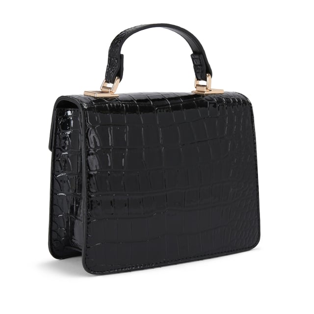 This Jessica Top Handle Bag features a black exterior with large croc print. There is a gold branded plate on the front flap.15cm (H), 17cm (L), 7cm (D). Strap length: 125cm. Gold tone chain strap with two inserts.