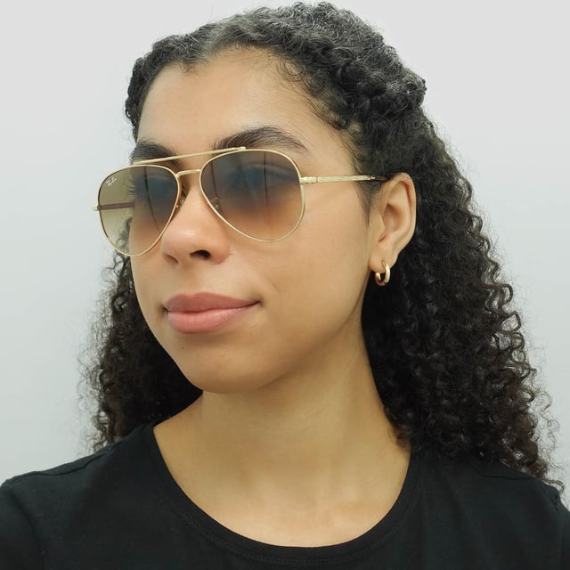 Ray-Ban Aviator Unisex Polished Gold Light Brown Gradient RB3625 New Aviator  Sunglasses are a fusion of classic design and modern innovation. With a nod to the iconic aviator silhouette, these sunglasses feature a sleek metal frame and bold double bridge, delivering a contemporary twist on a beloved style. The updated, slightly squared lenses offer a fresh take on the traditional aviator shape, exuding confidence and sophistication. Crafted with precision and attention to detail, these sunglasses not only make a fashion statement but also provide exceptional UV protection, ensuring both style and eye safety.