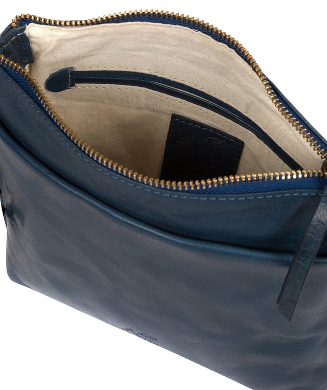 The 'Nikita' cross body bag from Conkca London is handcrafted from natural leather for a classic yet contemporary finish - perfect for elevating any look. With two full-length slip pockets on the exterior of the bag which arte perfect for on-the-go storage, complemented by a 100% cotton lining for a flawless finish. Comes with an adjustable leather strap and is adorned with the unimitable Conkca London squirrel logo and charm.