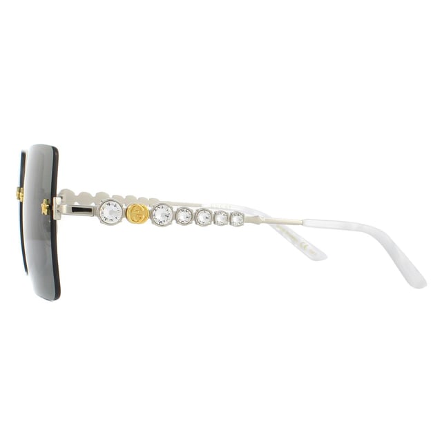 Gucci Sunglasses GG0644S 001 Silver Greyare incredibly glamorous with the large rimless square lenses set into the frame with star details screws. Leage crystal feature down the temples alongside the GG logo to great effect..