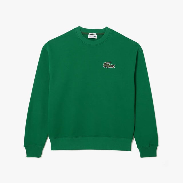 Unisex Lacoste Loose Fit Crocodile Badge Jogger Sweatshirt.- Loose fit, large cut, lowed shoulders.- Fleece crew neck.- Large crocodile on chest.- Embroidered crocodile sewn onto nape of the neck.- Organic unbrushed cotton fleece.
