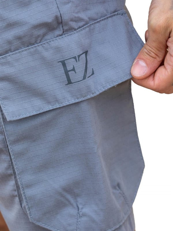 Expertly designed with top-quality ripstop fabric, these Enzo technical cargo shorts offer unparalleled durability. The convenient cargo pockets and zip side pockets make for easy storage, and the elasticated waistband with an adjustable drawstring ensures a comfortable fit. Upgrade your wardrobe and gear with this must-have for any outdoor enthusiast.