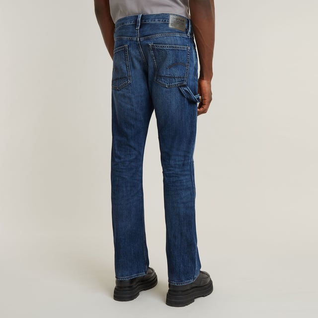 Zip fly. 5 pockets, incl. coin pocket caught in the seam. Tool loop at the side. G-Star RAW label at the back, made from a leather-like paper fabric. Zip & button closure. Mid waist. The Lenney jeans is designed in a straight fit that widens in a bootcut silhouette. The tool loop at the side adds interest. 100% Cotton. Rigid. Weight 11.3 oz. Bootcut