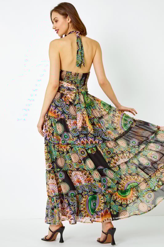 Abstract Halter Neck Tiered Maxi Dress from Roman. Give a nod to the psychedelic 70’s with this printed maxi dress. Cut from a smooth woven fabric this piece features a modest round neckline and is designed in a Summer-ready sleeveless, halter neck style. Adorned in a mesmerising mixed print this piece falls in tiers in a fit and flare style to a modest maxi length. Pair with barely-there heels and a jacket for a garden party or add sandals and a light knitted cardigan for evening beach walks!