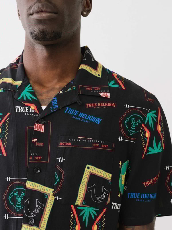 Grab your luggage and head to somewhere tropical in the Resort Print Camp Collar Shirt. Crafted from a soft woven fabrication, this men’s shirt features an allover conversational resort print, camp collar, short sleeves, and button-front closures.