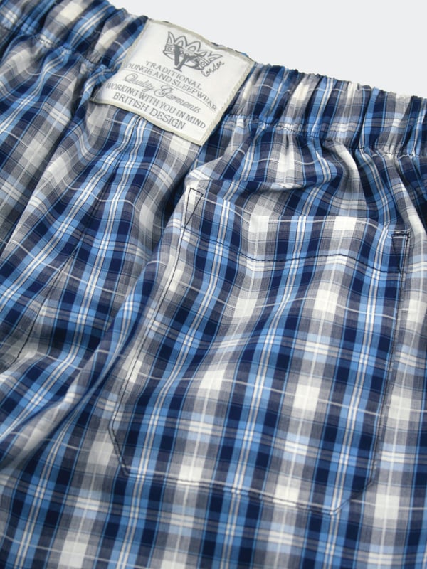 'Windsor' summer unisex longer length lounge shorts in a Navy, Blue and white woven check fabric.
100% Cotton
Machine Washable
Cool luxury woven Cotton fabric
Comfortable jersey inner waistband
Unisex
Drawcord waist
These Blue check PJ and loungewear shorts are for all to wear at any time of day! Great for holidays too! Traditional but also on trend!  Girls - they look fantastic rolled up to make them shortie shorts :)
Check our size guide for your size