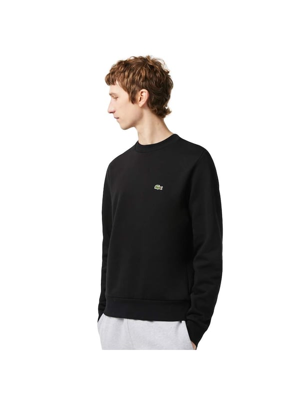 Solid-colored sweater with a round neckline, ribbed cuffs and subtle logo patches in a regular fit.