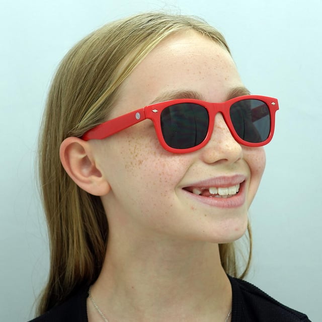 Smarty Rectangle Kids Red Grey X2054  Sunglasses Brighten your child's day with SMARTY Designer Sunglasses model X2054E, ideal for kids aged 3 to 7 years old. These rectangular-shaped sunglasses feature a vibrant red frame with durable plastic arms and grey lenses, offering superior UV protection and a bold, playful look. The X2054E model combines trendy design with kid-friendly comfort and durability, making them perfect for any outdoor adventure. Available at an unbeatable discount from the regular retail price, these designer sunglasses provide exceptional quality and value. Give your child the gift of stylish sun protection with SMARTY.