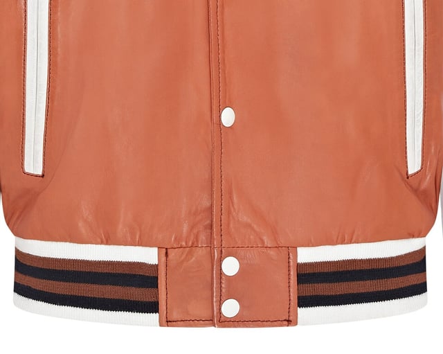 Introducing the Men's Baseball Leather Jacket, a perfect blend of classic varsity style and modern craftsmanship. This letterman bomber jacket features contrasting sleeves and a striped knit ribbed collar, waistband, and cuffs for a timeless athletic look. The press studs front closure and embroidered brand logo patches on the chest and sleeves add a touch of authenticity and flair. Designed with practicality in mind, it includes two jet pockets at the waist and two inside welt pockets for your essentials. The panelling to the back of the jacket ensures a tailored fit and superior comfort.

Contrasting sleeves for a stylish look
Striped knit ribbed collar, waistband, and cuffs for a classic finish
Press studs front closure for easy wear
Embroidered brand logo patches on the chest and sleeves for added detail
Two jet pockets at the waist and two inside welt pockets for convenience