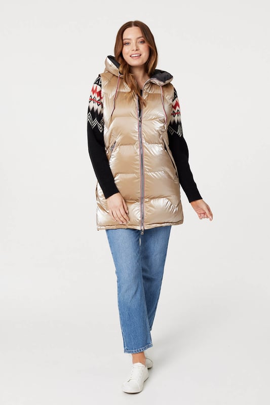 Add a puffer vest like this one to a transitional season wardrobe. With a hood, zip front closure, pockets with a zip detail and a longline fitted shape dropping to thigh length. Layer over your favourite knit pullover and jeans for a look that's perfect for when the weather turns colder.