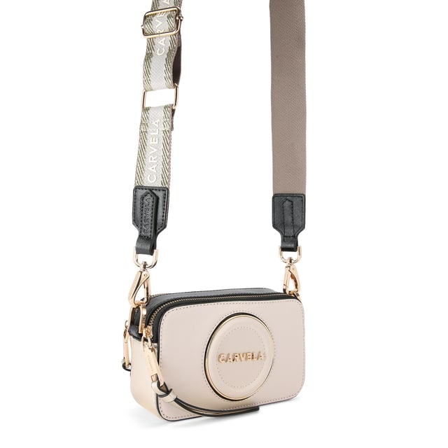 This Carvela Mini Roma Circle cross body bag features a bone exterior with round embossed branding on the front. There is branded gold hardware across the bag. Dimensions: 11cm (H), 18cm (L), 5cm (D). Strap length: 126cm.