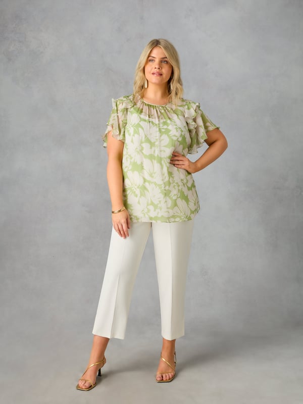 In a pretty green floral print, this blouse is cut from a soft, sheer chiffon, with a detachable jersey cami underneath for coverage. It has a round, gathered neckline, and angel sleeves with ruffle detailing. Keyhole and button fastening at the back neck add to its stylish feel, making this the perfect blouse to dress up or down.
