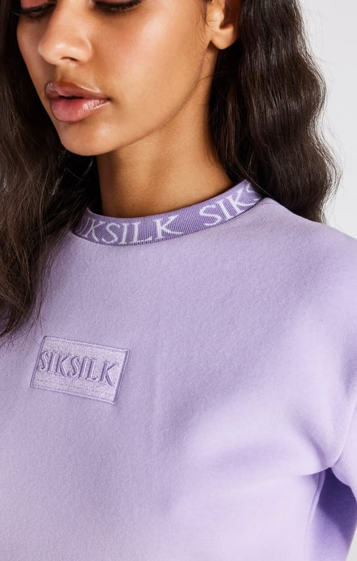 inchLilac Crop SweatshirtCropped fitSoft touchEmbroidered patchCrew neckPrinted neckbandMachine wash67% Cotton 33% Polyester inch