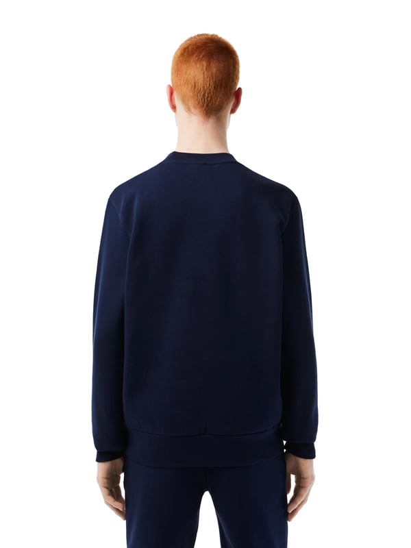 Solid-colored sweater with a round neckline, ribbed cuffs and subtle logo patches in a regular fit.