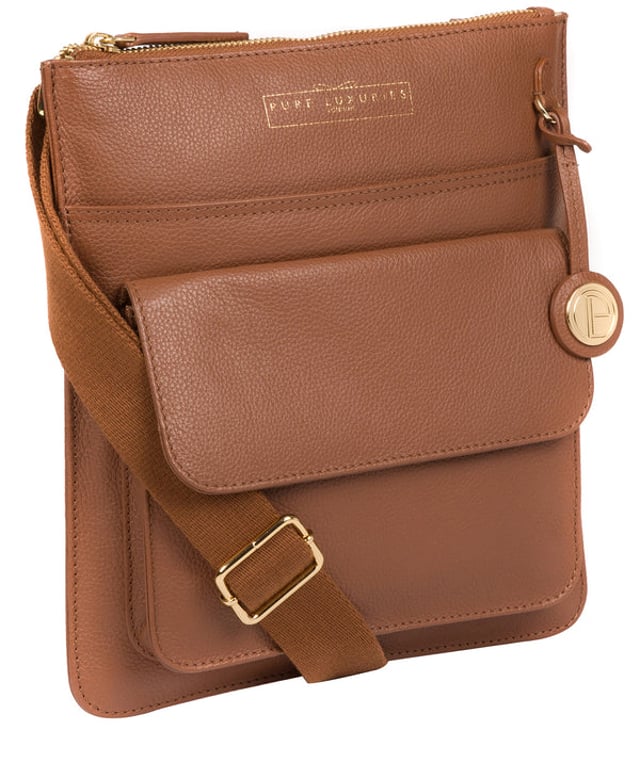 Crafted from supple leather, the 'Langley' cross body bag from Pure Luxuries London elevates a classic design with a luxury finish. A zip-over top fastening conceals the 100% natural cotton lined interior and is complemented by two slip pockets, ideal for maintaining an organised bag. Additional storage space is provided by a slip pocket and a press-stud fastened pocket. Adorned with an adjustable strap and finished with a beautiful Pure Luxuries London charm and logo for an elegant finish.