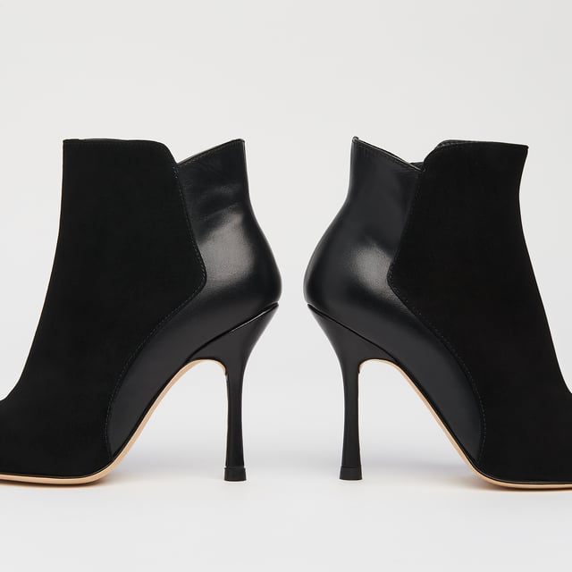 A sexy new style in our autumn/winter shoe collection, our Aliyah ankle boots have incredible shape. Crafted in Spain from a stylish blend of black suede and nappa leather, they have pointed toes, inside zips and 100mm slender heels with flared detail. Sophisticated and stable, wear them with autumn's midi dresses and sleek tailoring alike.