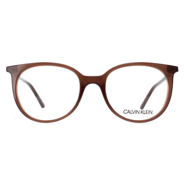 Calvin Klein Round Womens Milky Brown CK19508  Glasses are a stylish and bold accessory that will make a statement with any outfit. These glasses feature a unique and contemporary design, with a sleek round frame that is both eye-catching and fashionable. The frame is made from high-quality acetate that is lightweight and durable, ensuring long-lasting wear and comfort.