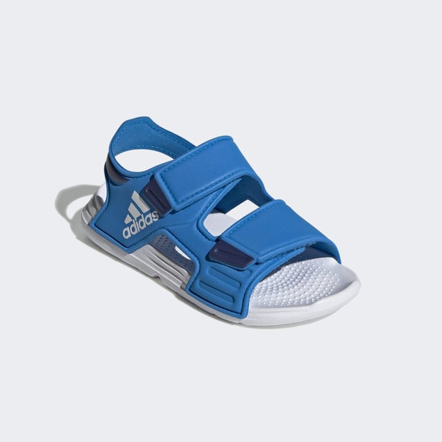 Sunscreen, check. Bucket hat, check. Blow-up unicorn? Maybe later. Let your aquanaut explore the shore in these kids' adidas sandals. Adjustable hook-and-loop straps create a snug fit that adds oomph as they skip stones. A grippy outsole leaves tracks in the sand as the sun sets on their perfect day.  - Regular fit - Hook-and-loop closure - EVA bandage upper - Textile lining - Contoured footbed - Lightweight EVA outsole  Shipped by adidas