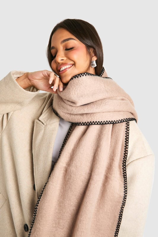 Blanket Stitch Trim Knitted Scarf Knitted scarf with distinctive stitch detailing
Contrasting edge stitching for a stylish finish
Generous length for versatile styling options
Soft, cosy texture for ultimate comfort
Subtle fringe detailing at the ends for added flair
Wrap yourself in effortless style with this chic knitted scarf from Boohoo. The eye-catching stitch detailing and contrasting edge stitching add a touch of sophistication to this casual accessory. Perfect for those chilly autumn days or crisp winter evenings, this scarf is your go-to companion for staying warm whilst looking fabulous. Drape it loosely over a leather jacket for an edgy look, or wrap it snugly around your neck with a cosy jumper for a more laid-back vibe. Its versatility makes it ideal for various casual occasions, from coffee dates with friends to family gatherings. The generous length allows for multiple styling options, so you can customise your look to suit your mood. Whether you're heading to the shops or enjoying a weekend stroll in the park, this scarf will keep you looking trendy and feeling snug.